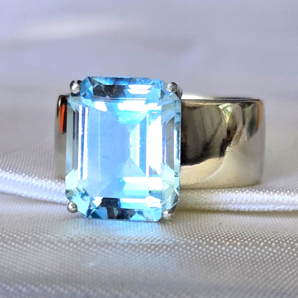 Emerald Cut Sky Blue Topaz On Wide Sterling Silver Band (small chip on topaz)